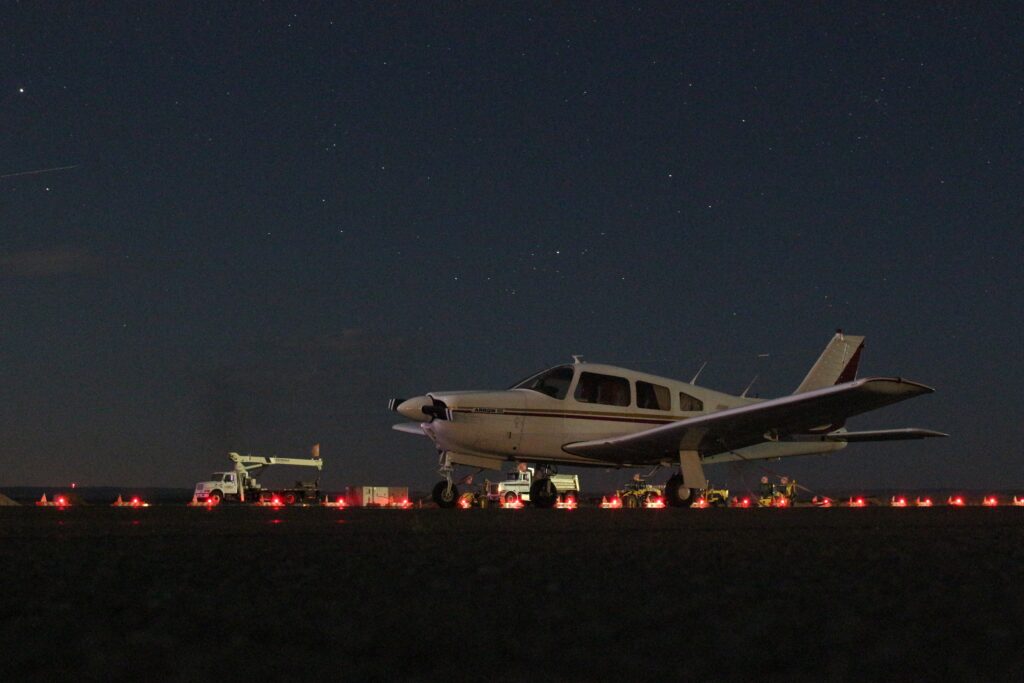 private plane landing at night at an airfield